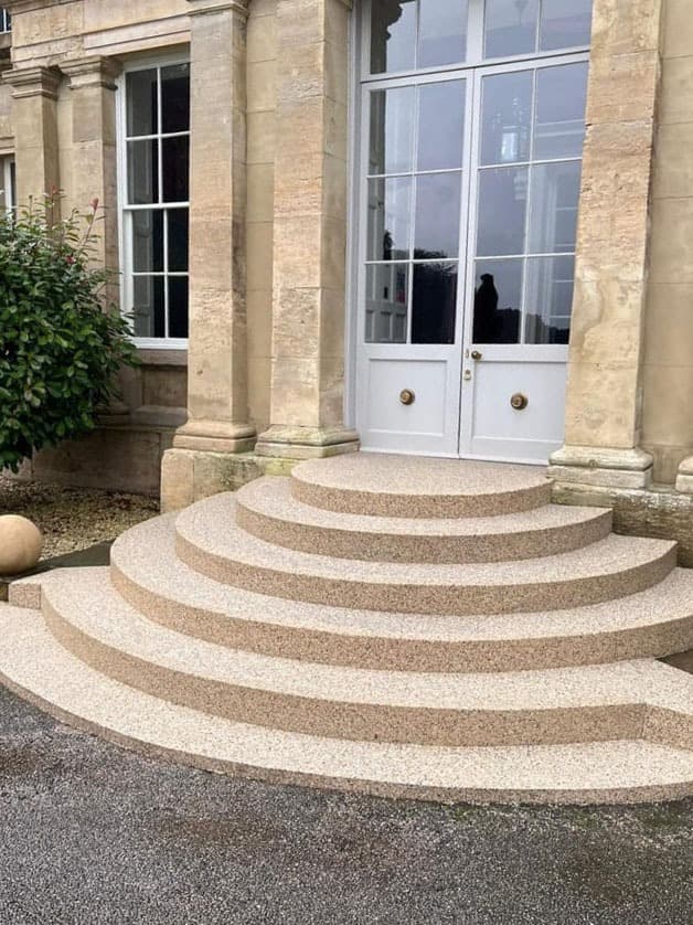 Curved Resin Rock entry steps sweeping up to a manor doorway